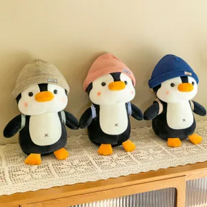 Cute plush penguin toy with knitted beanie and mini backpack, soft stuffed animal doll.
