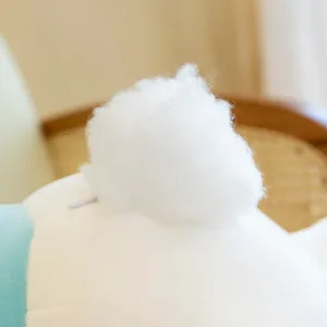 Close-up detail of a cute plush rabbit pillow showing soft fluffy tail and zipper design.