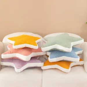 Plush star pillow detail showing colorful five-pointed star cushions neatly stacked on sofa.