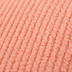 Soft pink ribbed plush fabric texture detail close up for cozy home decor cushion pillow.