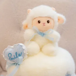 Vue détaillée d'une jolie poupée agneau en peluche sur socle de gâteau blanc avec ruban bleu.