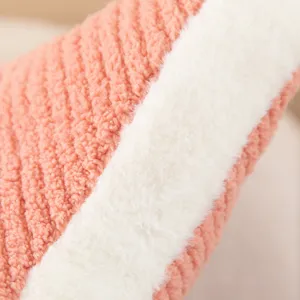 Plush cushion detail shot featuring soft pink sherpa and white plush stripe texture fabric.