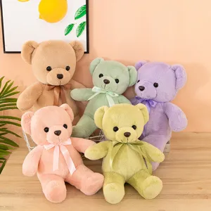 Cute colorful plush teddy bear toy detail, soft stuffed animal doll with ribbon bow decoration.
