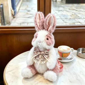 Gedetailleerd overzicht van de schattige roze-witte pluche konijnenrugzak, gezellig café.