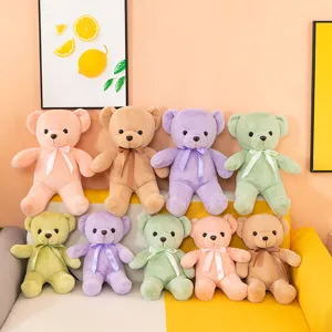 Detailed close-up view of colorful plush teddy bear toys with sweet ribbons for kids gifts.