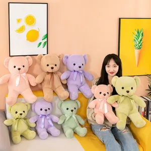 Detail view of colorful plush teddy bear toys with ribbons, soft and cuddly and cute.