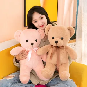 Cute plush teddy bear stuffed doll with ribbon bow, soft huggable toy for kids and home decor.