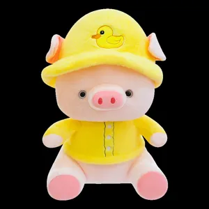 Close-up detail of the cute plush pig toy wearing a yellow hat and shirt, soft and cuddly.