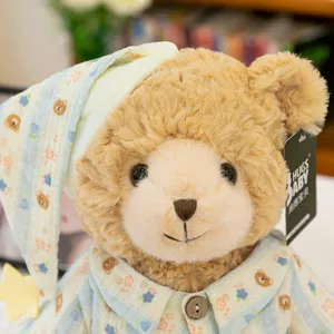 Close-up detail of cute brown plush teddy bear wearing cute pajamas and sleeping cap.