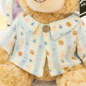 Plush bear toy detail shot, cute pajamas with stripes and floral print, soft fabric texture.