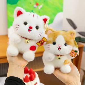 Cute lucky cat plush toy detail, fluffy texture with lucky bell pendant for bags or desk.