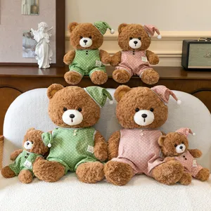 Detailed view of cute plush teddy bear toys wearing polka dot pajamas and nightcaps cozy.