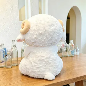 Close-up of the fluffy white sheep plush toy, showing soft fleece texture and cute curved horns.