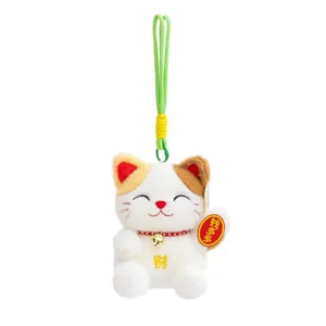 Cute lucky cat plush pendant, soft stuffed doll with green lanyard and bells. Detail view.