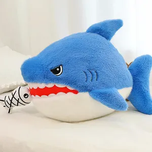 Detailed close-up of a cute blue shark plush toy biting a small fish, soft and cozy texture.