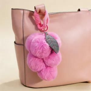 Cute fluffy grape pom pom bag charm, plush keychain pendant for handbags and keys decor.