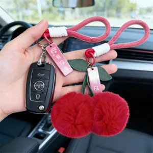 Cute red cherry plush keychain and bag charm with soft pom-pom balls and stylish woven lanyard.