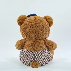 Cute brown plush bear detail showing back view, soft fuzzy texture and plaid shorts design.
