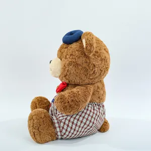Cute plush teddy bear toy with blue beret and brown plaid shorts, soft stuffed animal doll.