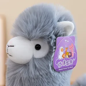 Grey fluffy alpaca plush toy close up, soft stuffed animal doll for kids and home decor.