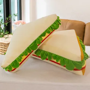 Sandwich plush pillow detail showing soft fabric, cute lettuce layers, and cozy home sofa setting.