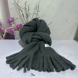 Dark green plush fringe scarf detail, soft and warm winter accessory for women and men.