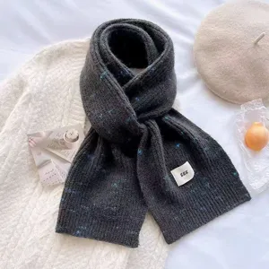 Cozy winter dark grey knitted scarf with blue speckles, thick warm stylish accessory for women.