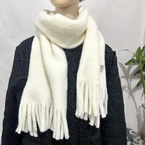 Detailed view of white knitted tassel soft warm scarf for women and men in winter daily use.
