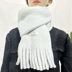 Detailed view of soft plush winter scarf with fringe, cozy warm apparel detail view.