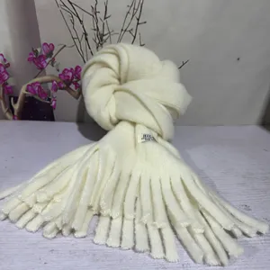 Detail view of the soft solid color winter knitted tassel scarf for women and men.