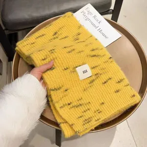 Close-up detail of cozy yellow knitted winter scarf, soft texture, warm and thick design.