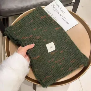 Green knitted cashmere scarf winter warm thick soft scarf with cute label detail cozy accessory.