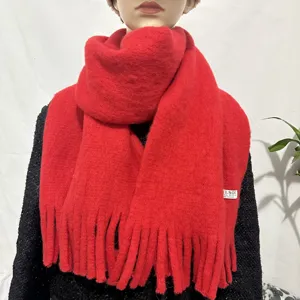 Red cashmere-feel knit scarf detail, soft texture and fringe hem close-up display.