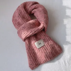 Detalle de bufanda de lana tejida, calentador de cuello rosa de invierno con etiqueta tejida.