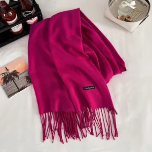 Fuchsia cashmere feel winter scarf detail view with elegant fringes and texture display.