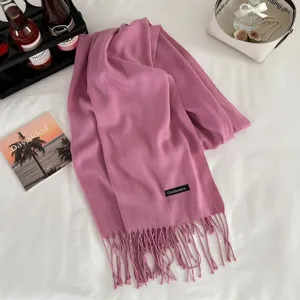 Pink cashmere-feel winter scarf with fringe detail, cozy warm fashion wrap shawl.