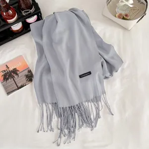 Cozy grey imitation cashmere winter scarf featuring elegant fringe details for daily warmth.