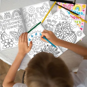 Kids coloring book detail shot showcasing butterfly and flower line art designs for creative DIY art.