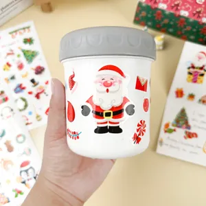 Christmas thermal jar decorated with cute Santa Claus stickers, ideal for holiday party.