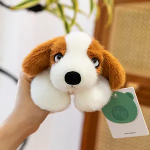 Close-up of cute brown and white plush puppy toy detail, soft fluffy fabric and hang tag.