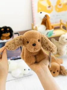 Cute brown puppy plush toy detail, soft palm-sized stuffed animal doll for kids gift and room decor.