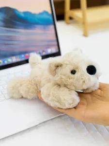 Cute mini puppy plush toy in hand, soft stuffed animal companion for kids birthday gift.