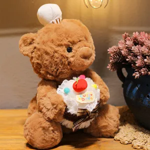 Cute chef teddy bear plush toy detail shot, soft brown stuffed animal holding a mini cake.