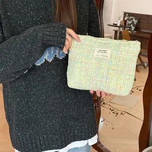 Tweed cosmetic pouch, multi-color bouclé clutch bag for travel makeup storage daily use main view.