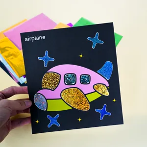 Kids DIY magic foil art sticker set with colorful airplane painting and shiny mirror foil sheets.