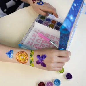 Glitter tattoo kit detail showcasing sparkling body art designs, stencils, and tools.