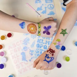 Kids glitter tattoo kit with colorful body shimmer powders, stencils and brushes for DIY fun.