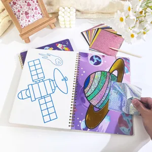 Detailed view of kids DIY magic foil art transfer book, showing sparkling space planet design.