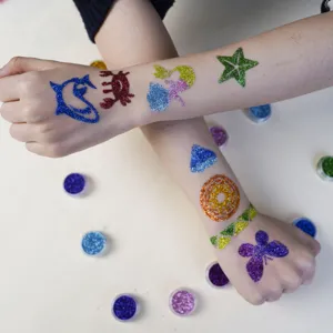 Children DIY body glitter tattoo kit with colorful sparkling powder and diverse shape stencils.