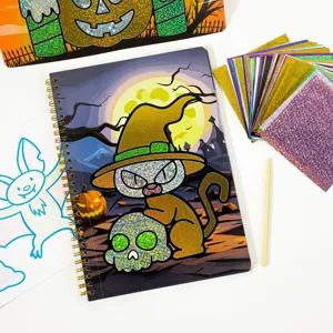 Halloween foil art kit detail showing colorful transfer sheets, notebook, and tools.